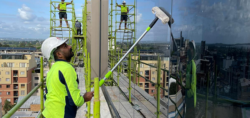 after builders cleaning team is washing the glasses